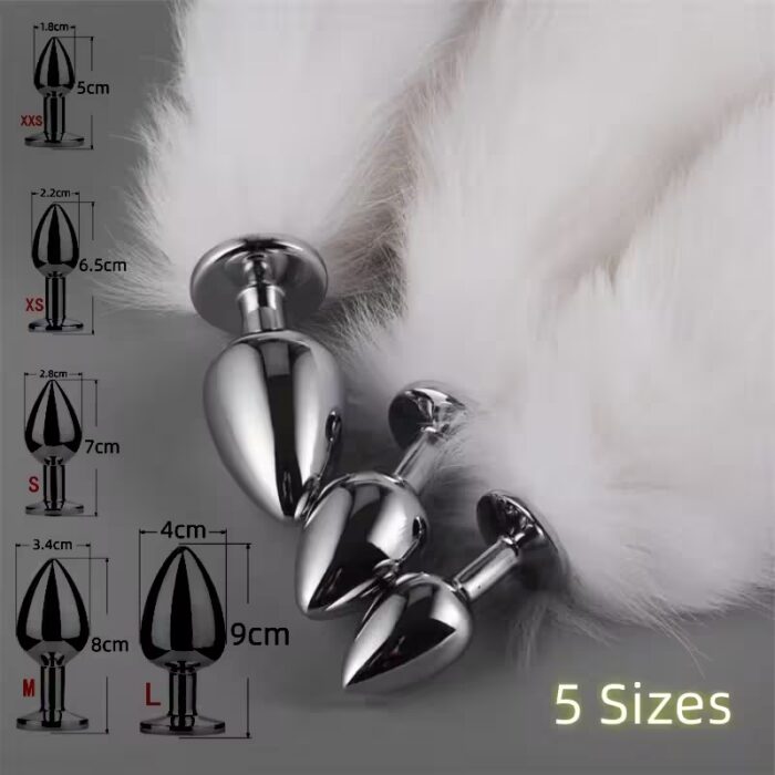 Five stainless-steel butt plugs of ascending sizes, each with a soft faux-fox tail attached