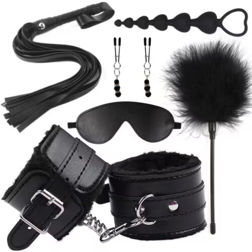 Complete erotic bondage kit for women including leather handcuffs, whip, blindfold, nipple clamps, and anal plug on black satin