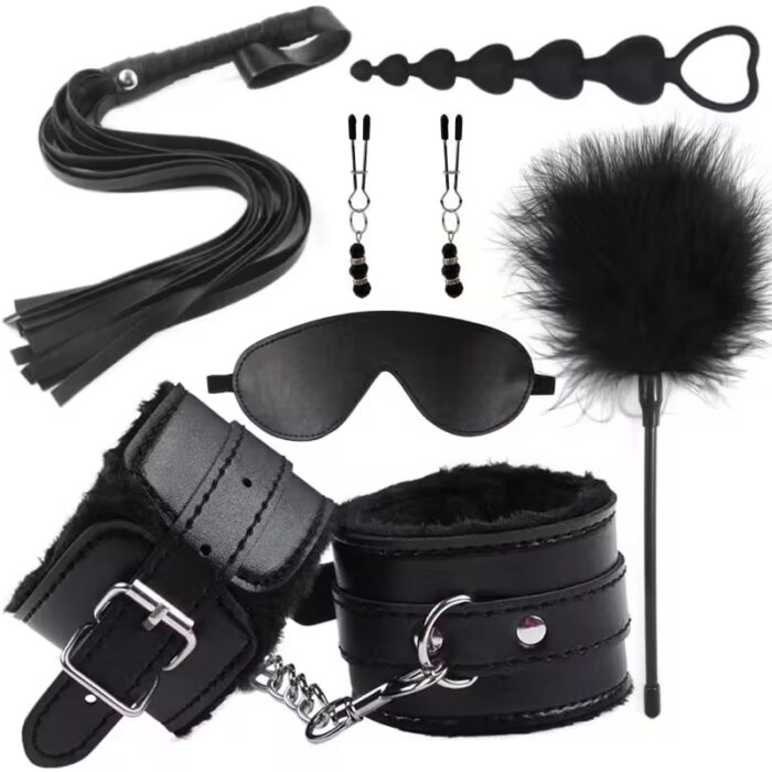 Complete erotic bondage kit for women including leather handcuffs, whip, blindfold, nipple clamps, and anal plug on black satin